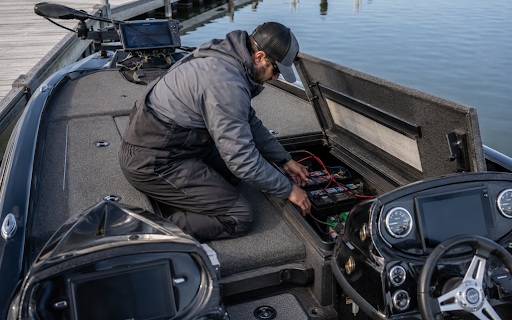 man looking at boat battery