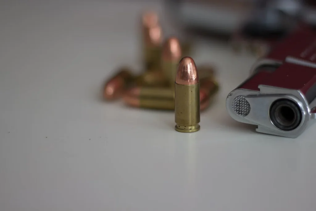 gun with bullets lying on counter