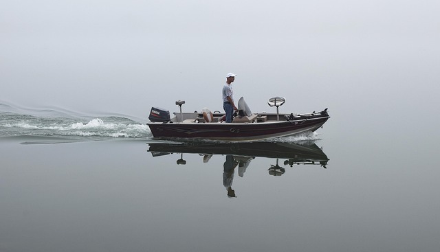 man in fishing boat on smooth water