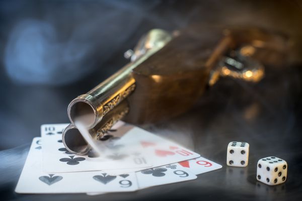 gun with cards and dice