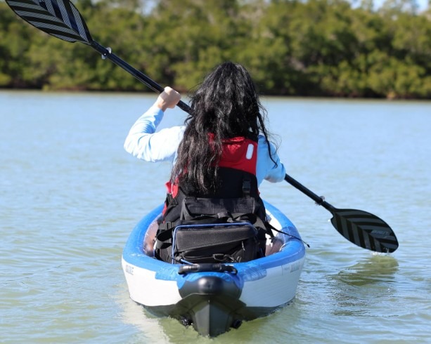 woman paddling an inflatable kayak