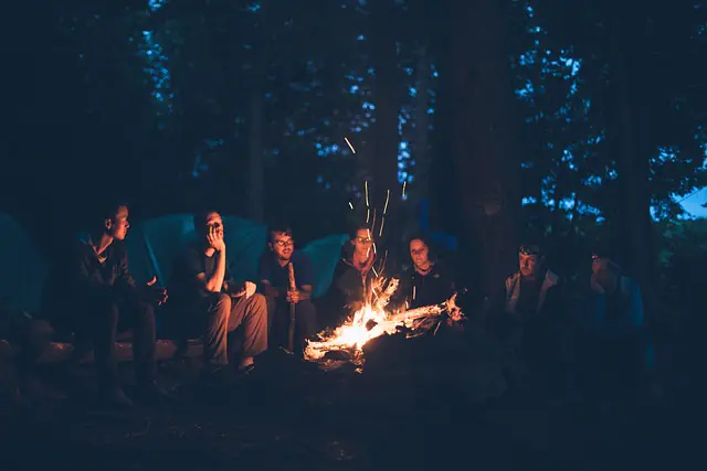 group camping around campfire